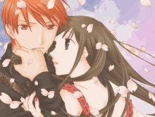 a man and a woman are hugging each other with petals falling from the sky