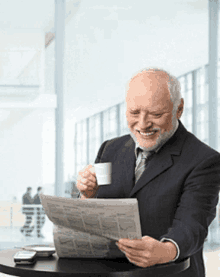 a man in a suit and tie is reading a newspaper and drinking coffee