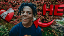 a young man is smiling in front of a red heart and the word he