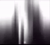 a black and white photo of a person 's face with a blurred background .