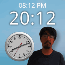 a man with glasses stands in front of a wall clock that says 10:12 pm