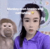 a woman in a purple shirt is standing next to a stuffed monkey with the caption monkey even knows she catfishing