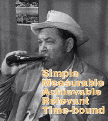 a man in a cowboy hat drinking from a bottle with the words simple measurable achievable relevant time-bound written below him