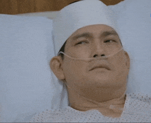 a man is laying in a hospital bed with an oxygen mask on his face