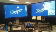 two computer monitors with dodgers on them