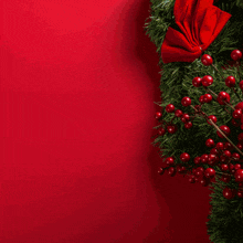 a woman stands in front of a christmas tree with the words malig mga written on the wall behind her