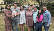 a family posing for a picture with a baby in the middle