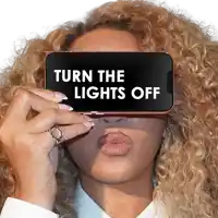 a woman with curly hair is holding a cell phone with the words turn the lights off on it