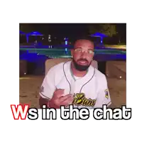 a man wearing a jersey that says ' ws in the chat ' is sitting in front of a pool