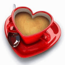 a cup of coffee in the shape of a heart with a spoon on a saucer .