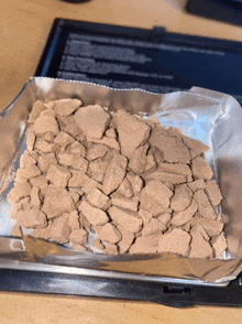 a pile of rocks in a foil wrapper on a table