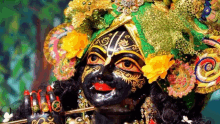 a close up of a statue of a deity with a flute in his hand .