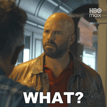 a bald man with a beard is talking to another man and says what