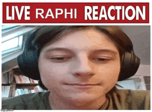 a young man wearing headphones looks at the camera with a sign that says live raphi reaction