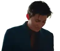 a man in a blue suit and tie looks down