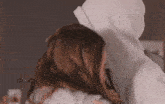 a man and a woman are hugging each other while the man is wearing a hoodie .