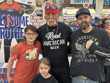 a man wearing a shirt that says real american beer poses with two children