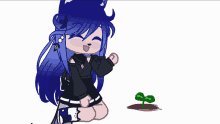 a girl with blue hair is kneeling down next to a small green plant