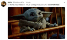 a picture of a baby yoda sitting in a crib with a tweet by brinis