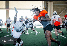 a football player with the number 97 on his jersey is being tackled by another player