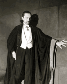 a black and white photo of a man dressed as a vampire