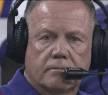 a close up of a man wearing headphones with a microphone