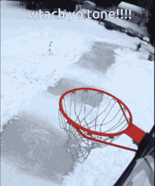 a picture of a basketball hoop in the snow with a caption that says wtach yo tone