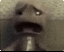 a blurry picture of a person 's face with their mouth open