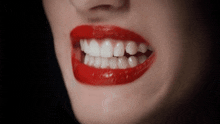 a close up of a woman 's mouth with red lips