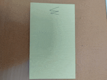 a yellow piece of paper with the letter m on it