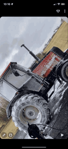 a phone screen shows a tractor with the number 455 on the side