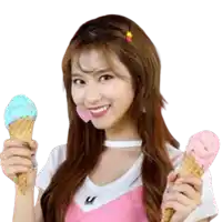 a woman in a pink dress is holding two ice cream cones