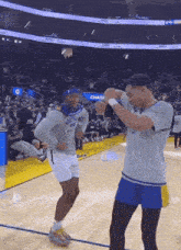 two men are dancing on a basketball court in front of a chase bank banner