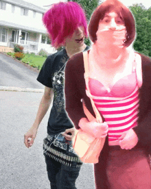 a girl with pink hair is standing next to a woman in a pink and white striped dress