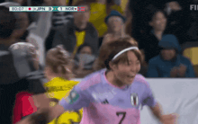 a soccer player in a pink jersey with the number 7 on the back