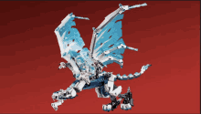 a lego dragon with a red background is flying in the air