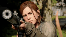 a woman is holding a gun in a video game and pointing it at the camera .