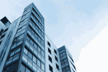 looking up at a tall building with a blue sky in the background