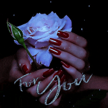 a woman with red nails is holding a purple rose with the words for you written on the bottom