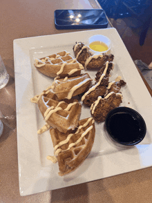 a white plate topped with waffles and chicken