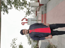 a young man stands in front of a sign that says cb