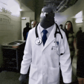 a man dressed as a doctor with a pigeon head and a stethoscope