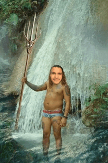 a man in a waterfall holding a trident with his face on it