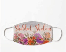 a face mask with flowers and the words shabbat shalom