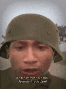 a man wearing a military helmet is talking in a foreign language .