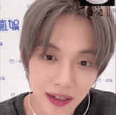 a close up of a person 's face with earphones on