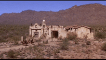 a desert landscape with a church in the foreground