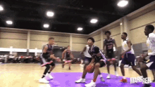 a group of young men are playing basketball in a gym with the words mar & reel on the bottom right