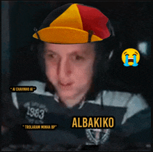 a man wearing a hat with the name albakiko written on it