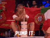 a woman is sitting in front of a portuguese flag and holding a straw and the words pump it are visible